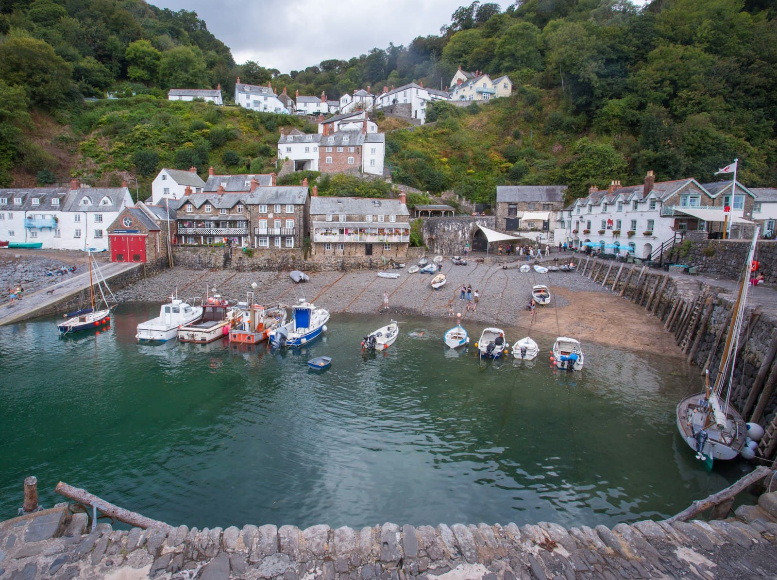 Fishing boats in a harbour below a hillside village