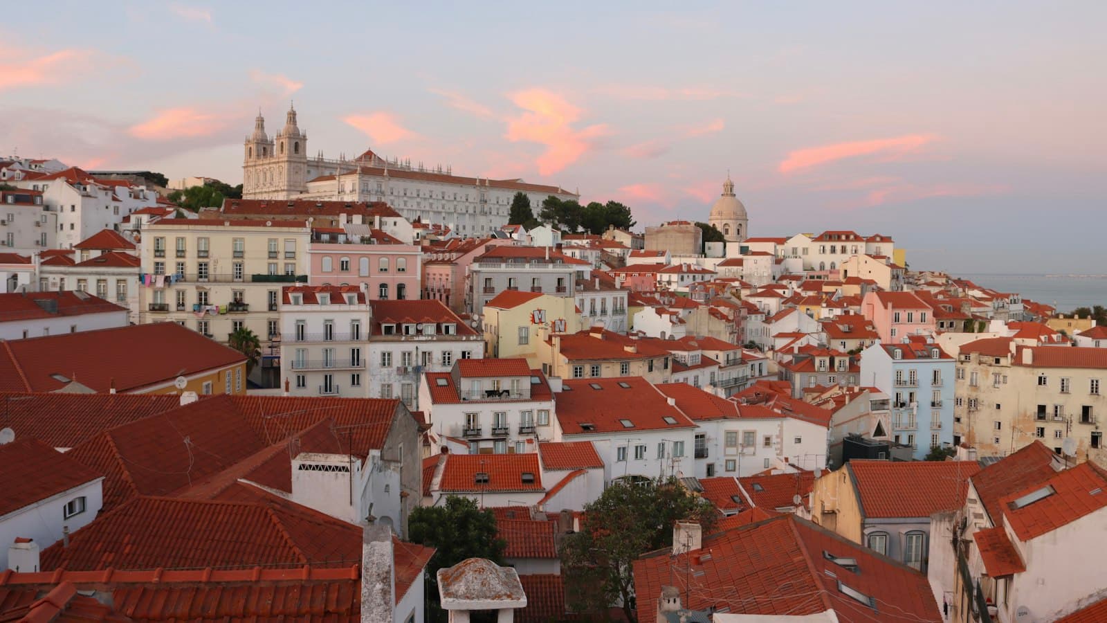 Terracotta rooftops of Lisbon at dusk