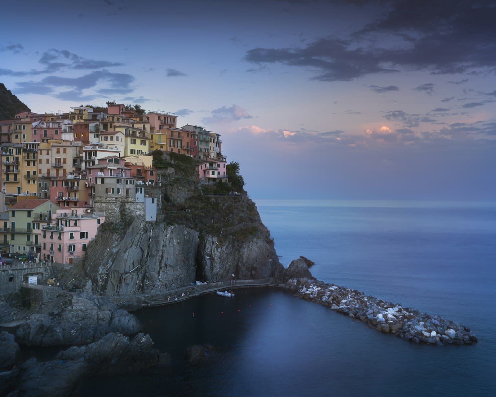 A cliffside village on the Mediterranean at dusk