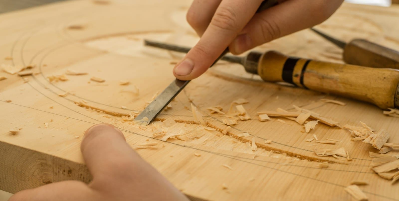 A craftsman carving a wooden bowl by hand